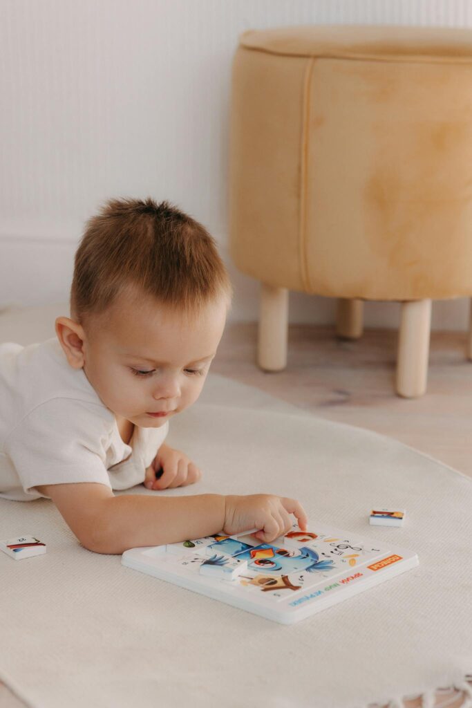 A young child exploring an educational picture book indoors, fostering early learning and curiosity.