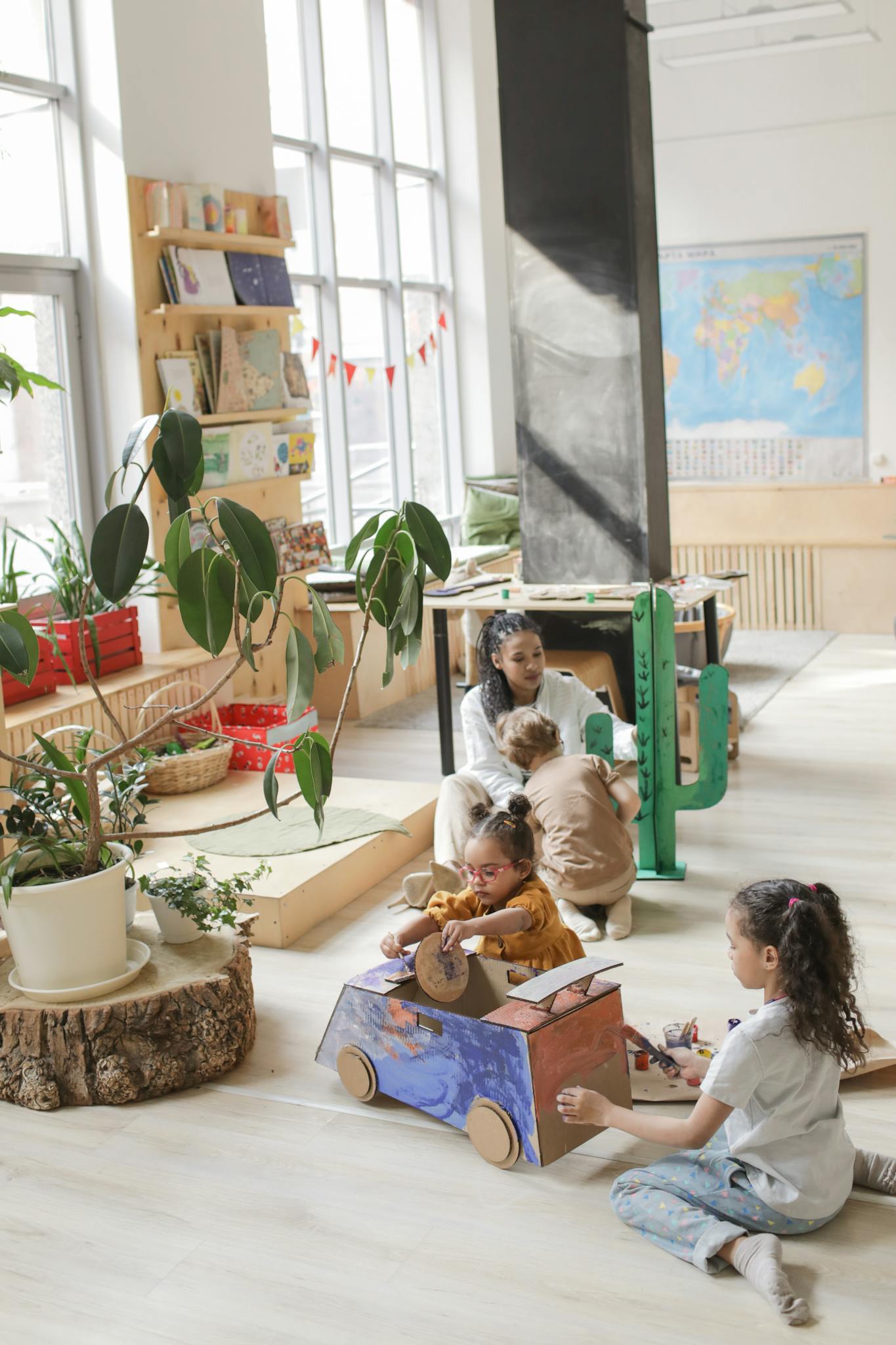 Children engaged in creative play in a well-lit classroom with educational materials.